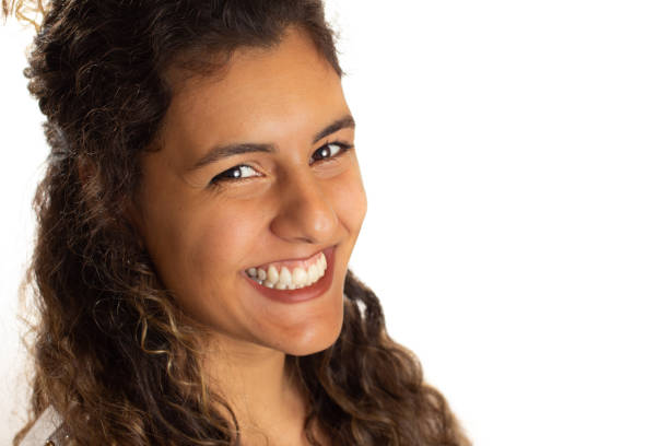 Portrait of a young woman looking at the camera. Profile, side view of african american girl. Isolated on white background.
