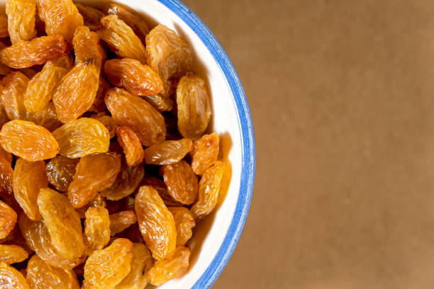 istock Healthy raisins in  porcelain bowl, close-up. Copy space for text. 1297083836