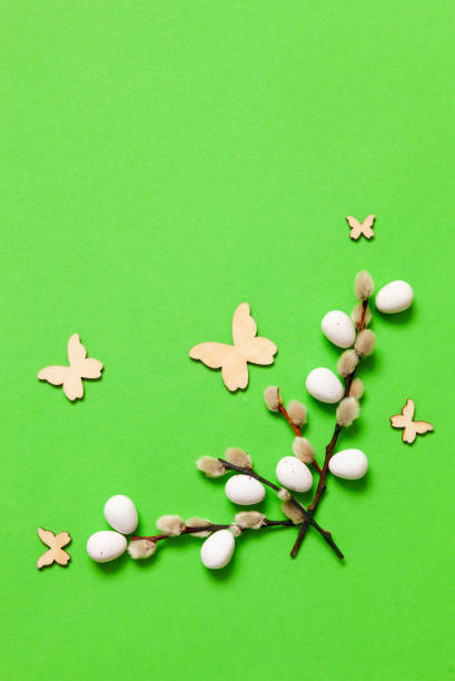 istock Top view of Easter eggs, pussy willows, butterfly and feathers. Easter concept on green background. Greeting card, space for text 1297088922