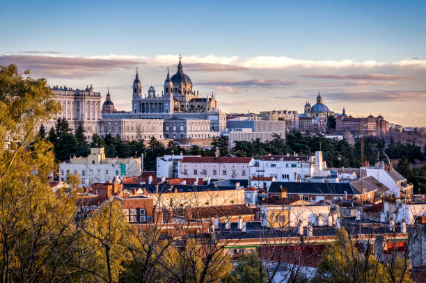 Madrid Almundena Cathedral and Palacio Real sunset cityscape panorama Spain Image of Madrid skyline with Santa Maria la Real de La Almudena Cathedral and the Royal Palace during sunset. madrid stock pictures, royalty-free photos & images