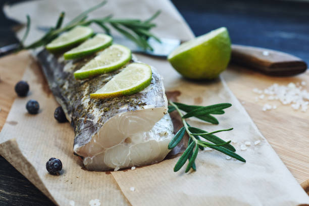 istock Raw fish with  lemon and rosemary. 1297091338