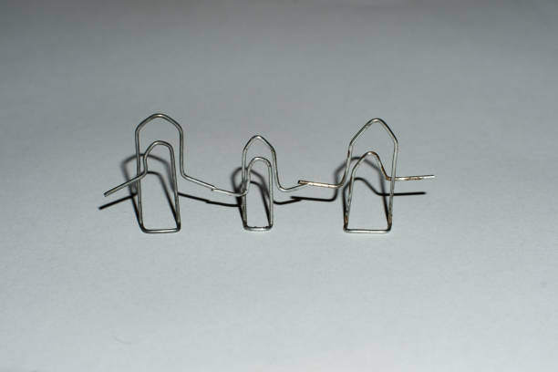istock Image of silver paper clip isolated on white background 1297091547