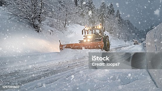 istock Snow Plow on the Street Full of Snow 1297091607