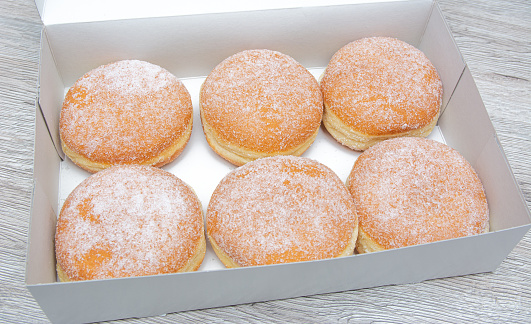 Fresh Donuts with icing sugar in a Donut Box