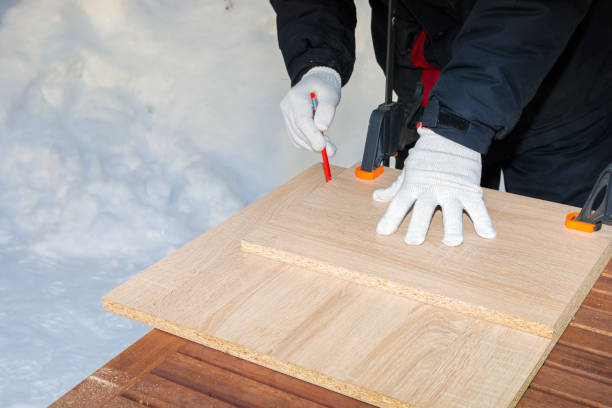 istock A man, a worker draws with a pencil on a chipboard board. 1297093646