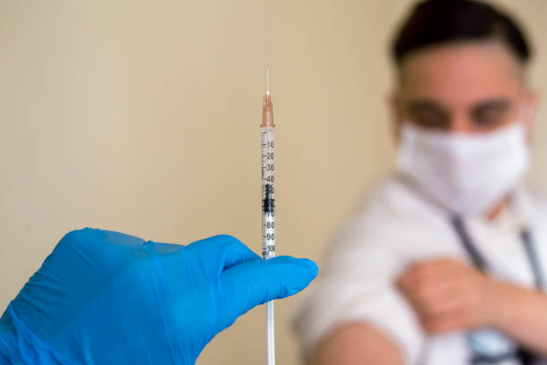 istock Man taking a vaccine from his doctor 1297094319