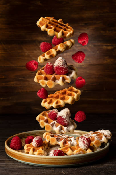 istock Mini flying waffles with raspberries and sugar 1297095347