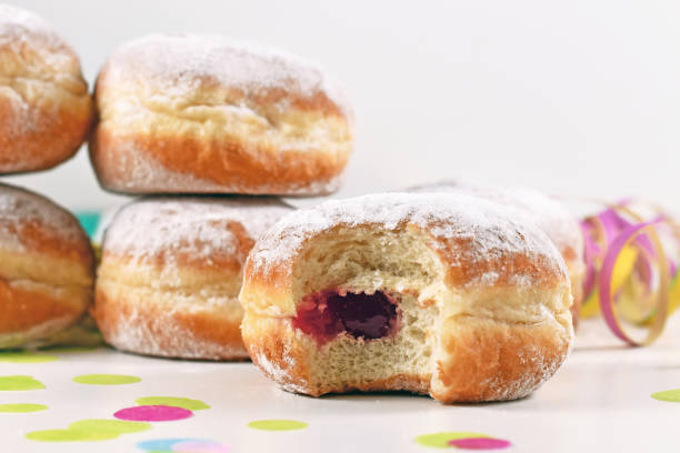 istock Jam filling inside a 'Berliner Pfannkuchen', a traditional German donut like dessert made from sweet yeast dough fried in fat 1297096111