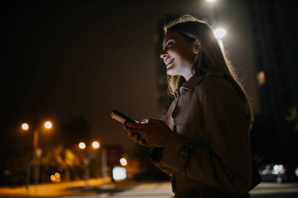 istock A young woman using her cellphone while out in the city 1297096622