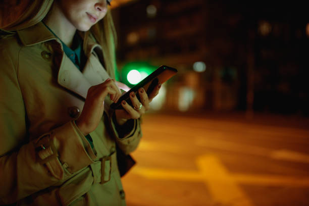 istock Young woman using her cellphone while out in the city 1297097967