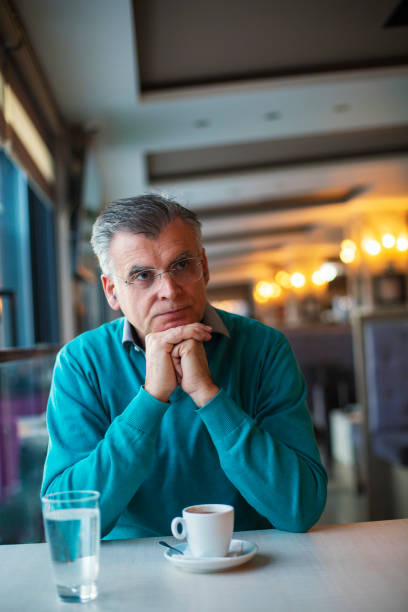 istock Senior man in a cafe 1297098944