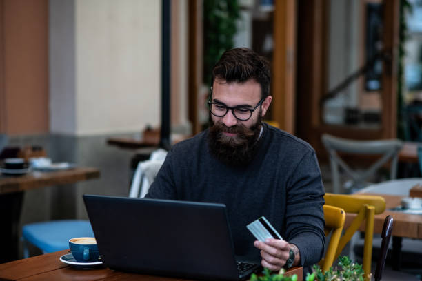 istock Young hipster sitting at cafe, shopping online. 1297099955