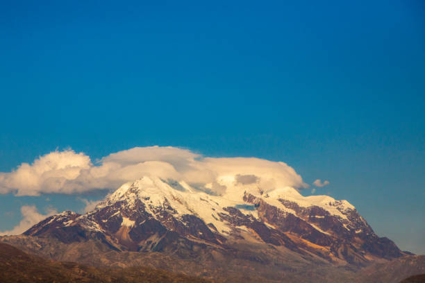 istock Beautiful and Emblematic snow-capped Mountain top with clouds 1297100364