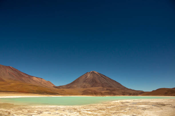 istock Turquoise salty lake, mountain range, blue sky on a clear day 1297101701