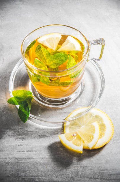 istock Closeup mint tea leaves in glass cup with lemon 1297104259