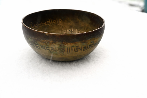 A copper tibetan bowl in winter