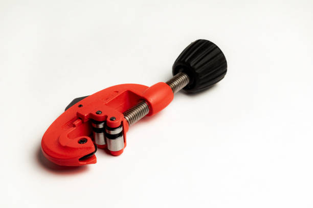 istock Red Plumber tool for cutting pipes on white background 1297106024