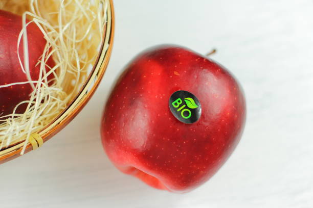 istock Red natural apple with bio sticker 1297106343