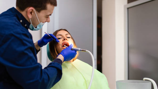 istock Young woman having dental exam 1297107189
