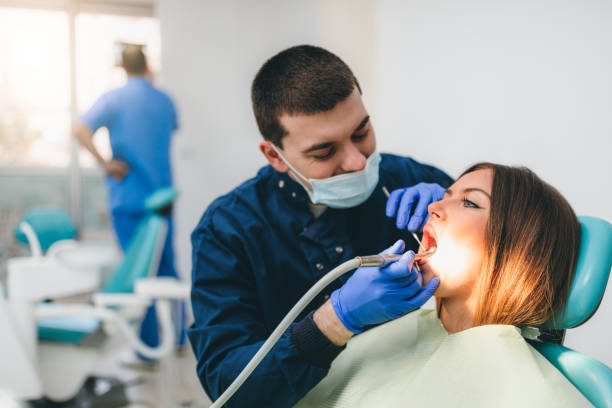 istock Young woman having dental exam 1297107195