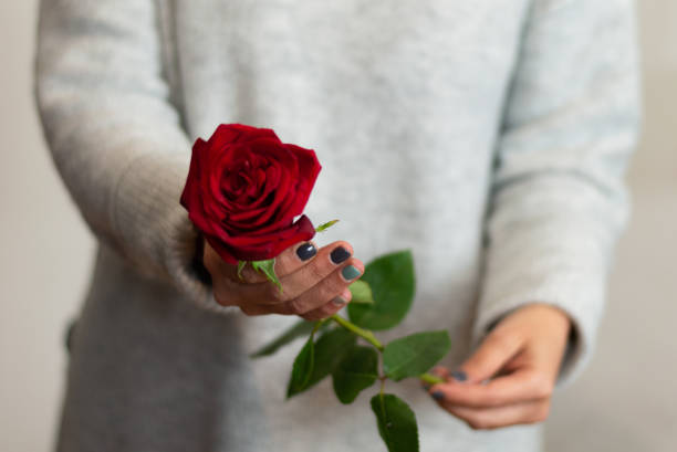 istock girl holding a red rose. selective focus. love concept 1297108842