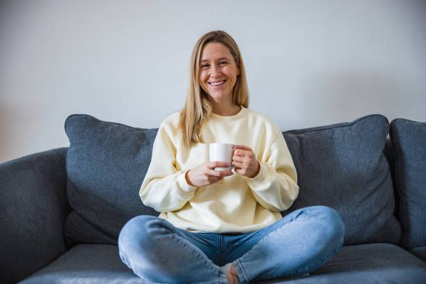 istock Young Woman Drinking Coffee And Relaxing At Home 1297111088