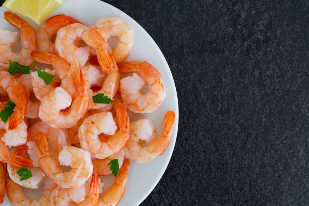istock Fresh shrimp served with lemon 1297111860
