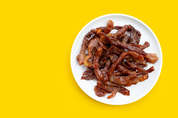 istock Deep fried sun-dried pork on yellow background. 1297113194