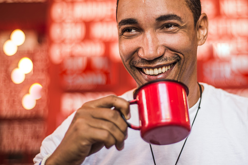 Afro-american man enjoying big cup of coffee