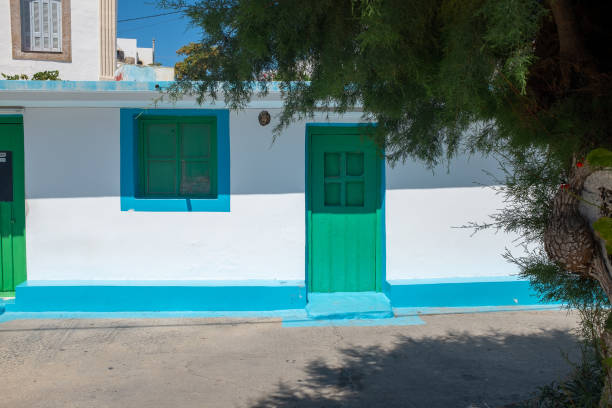 istock Lipsi, Dodecanese, Greece - August 18, 2019: House with green door and window 1297117092