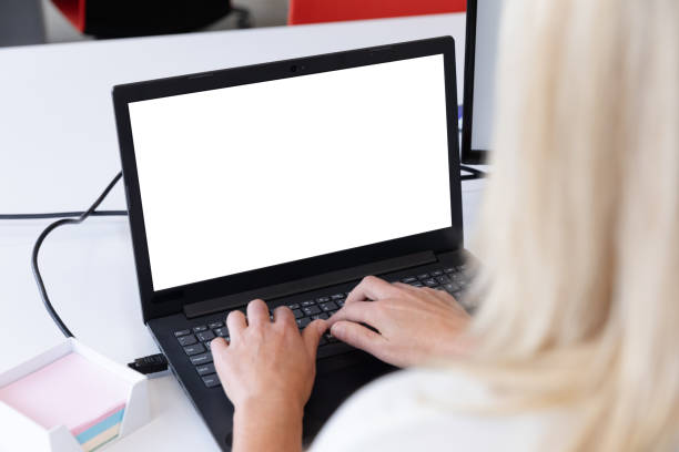 istock Caucasian businesswoman sitting using a laptop in a modern office 1297120046