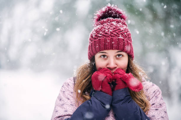 istock Beautiful woman heating up her hands 1297126596