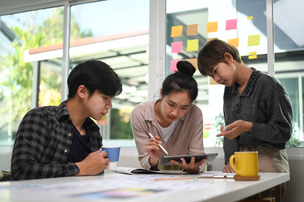 istock Them of creative designer discussing together on new project in modern conference room. 1297128183