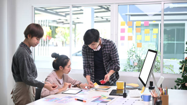 istock Team of creative designer sharing ideas on project in modern conference room. 1297128212