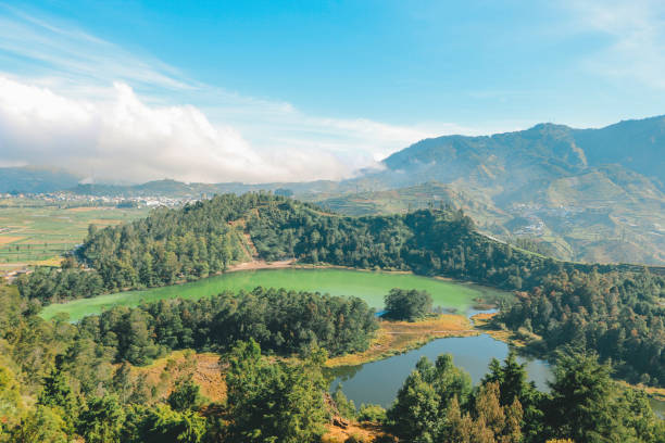 istock Morning view of Telaga Warna Lake with mountain background at Dieng Plateau, Central Java, Indonesia. Aerial View from Rock View Lamentations Wind Hill. 1297130452