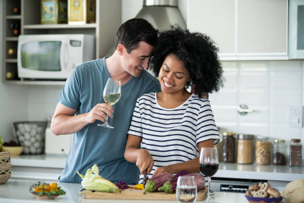 istock Romantic couple cooking together at home 1297130572