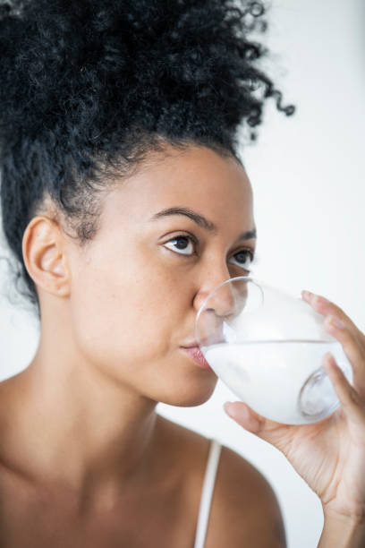 istock Young woman drinking water 1297131342