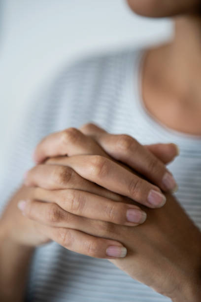 istock Young woman with hands clasped 1297131354