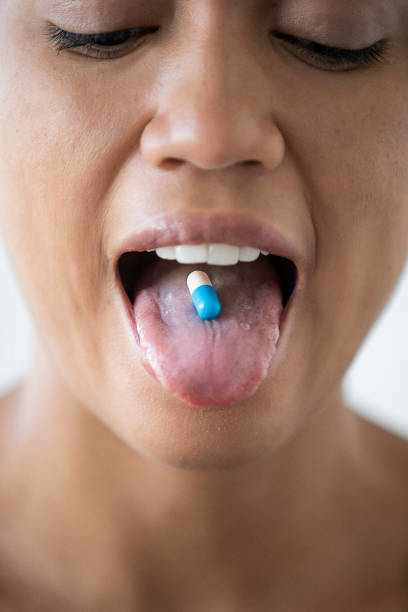 istock Young woman taking medicine 1297131358