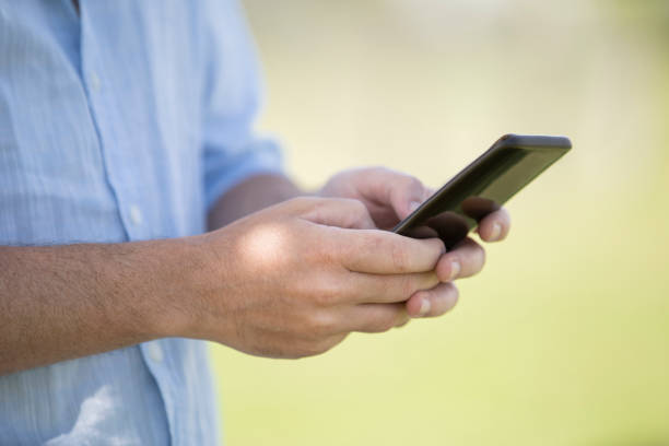 istock Close-up of man text messaging on smartphone 1297131483