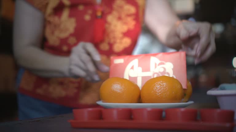 Asian senior women happy to celebrate Chinese New Year ,Red packet and mandarin oranges