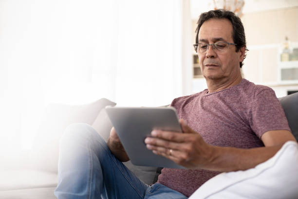 istock Senior adult using digital pad at home during daytime 1297132290