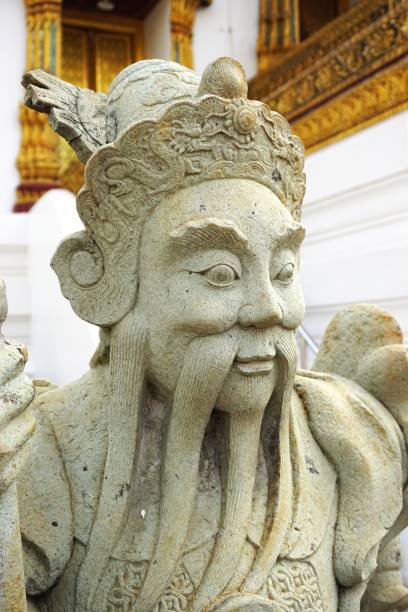 istock Ancient carved stone deity statue with crown and long beard 1297132892