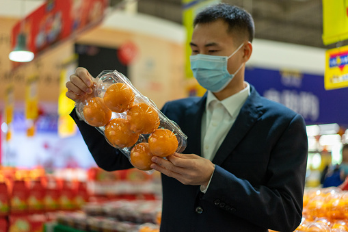 Men wear masks to pick fruits to prevent the spread of the epidemic