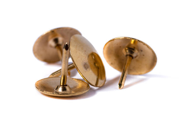 istock Closeup metal tacks isolated on a white. Office concept 1297136184