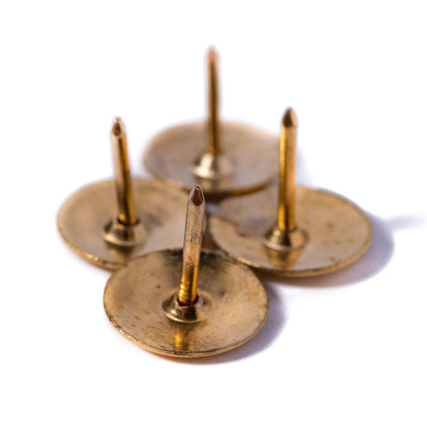 istock Closeup metal tacks isolated on a white. Office concept 1297136312