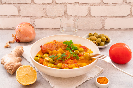 Traditional tagine plate with chicken, lemon and olive