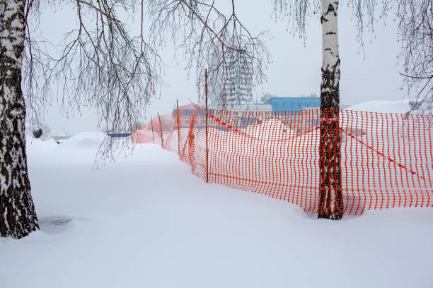 istock Plastic red safety net for construction site. Fencing repair work 1297141360