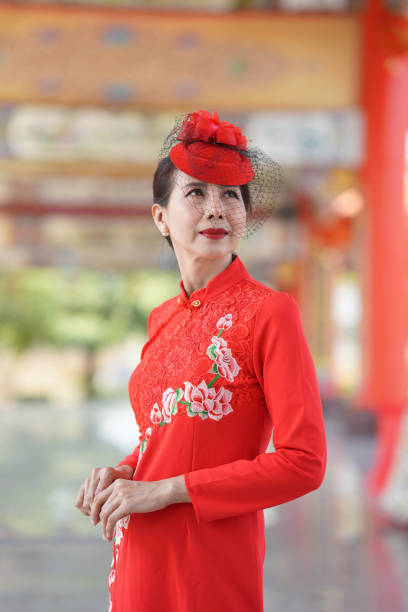 Elegant lady wearingredCheongsam dress at Chinese Shrine,Chinese new year concept.