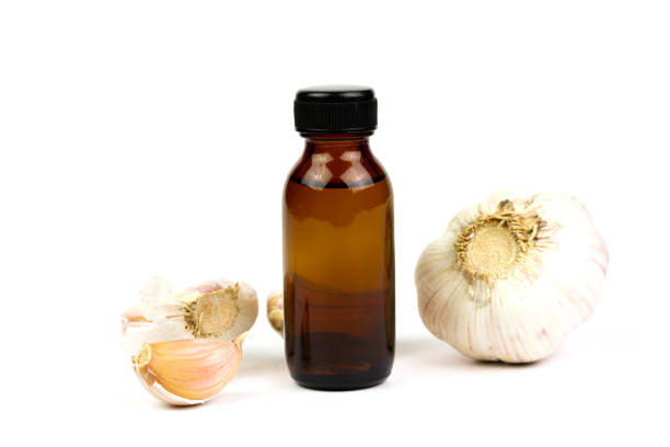 Small jar of honey and  garlic on glass table top